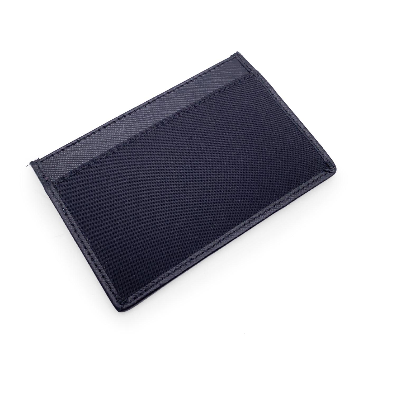 Prada black card holder in Saffiano leather and nylon. Jacquard Prada logo on the front. 2 exterior section and 1 middle section. 'Prada Milano' and 'Made in Italy' engraved inside. Details MATERIAL: Leather COLOR: Black MODEL: n.a. GENDER: Unisex