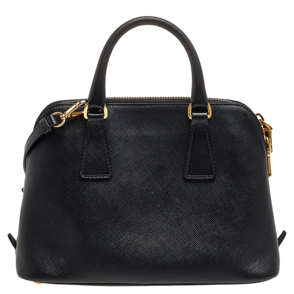 This stunning Promenade bag is high in appeal and style. Dazzling in a classy black shade, the bag is crafted from leather and features two rolled handles. The zip closure leads way to a nylon interior with enough space for your essentials and the