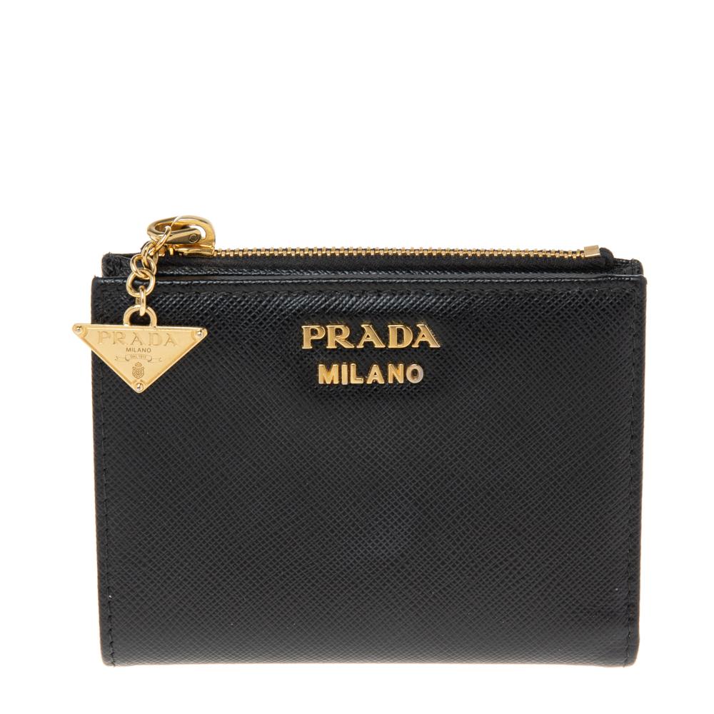 This compact wallet from the House of Prada will be your favorite! It is created using black Saffiano Lux leather, with a gold-tone logo lettering on the front. It features a nylon-leather interior. Carry this wallet and flaunt your luxe style!