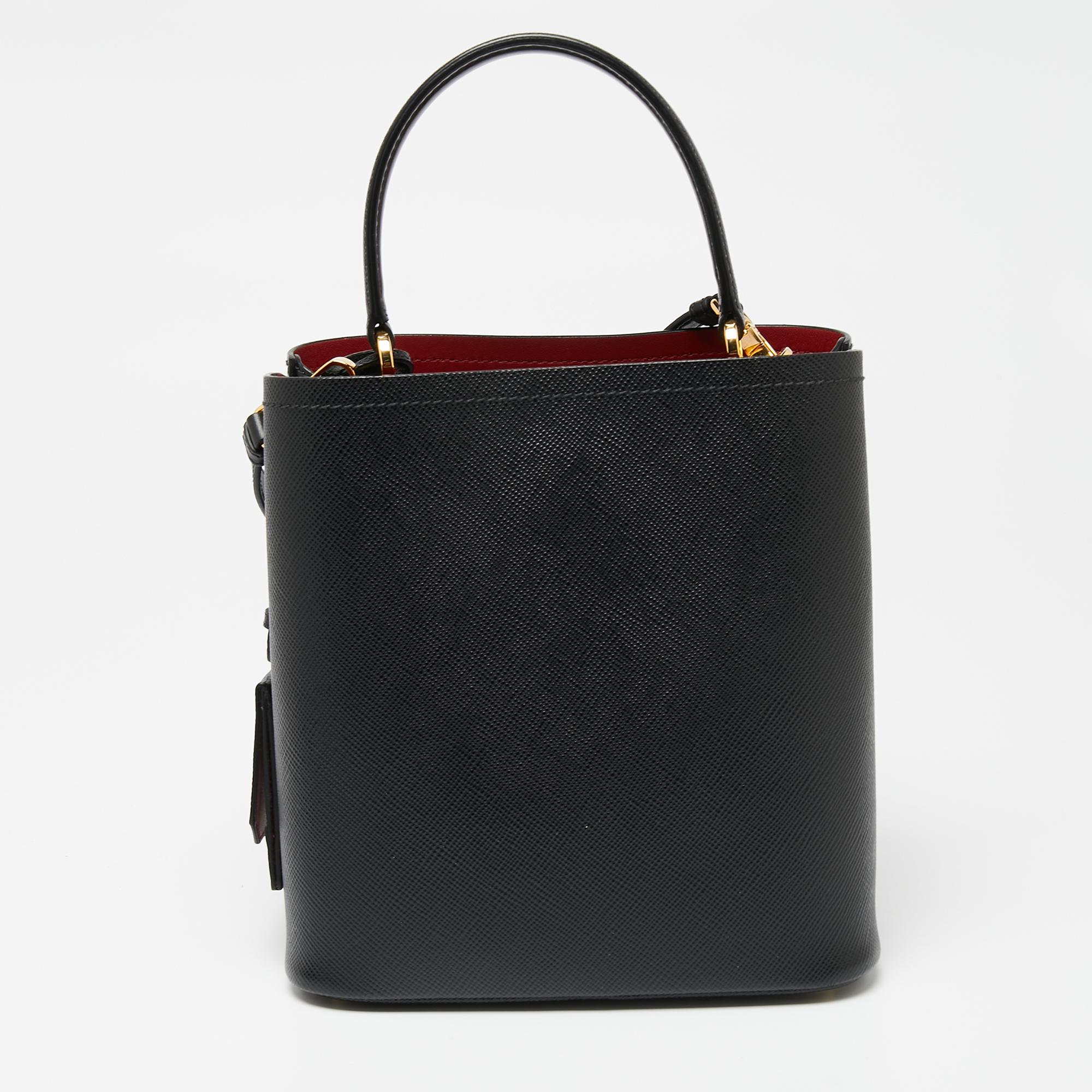 Distinctive in design and style, this Panier bag from Prada definitely deserves to be yours! It has been crafted from black leather and features a single top handle and the brand logo on the front. It opens to a spacious interior that can easily