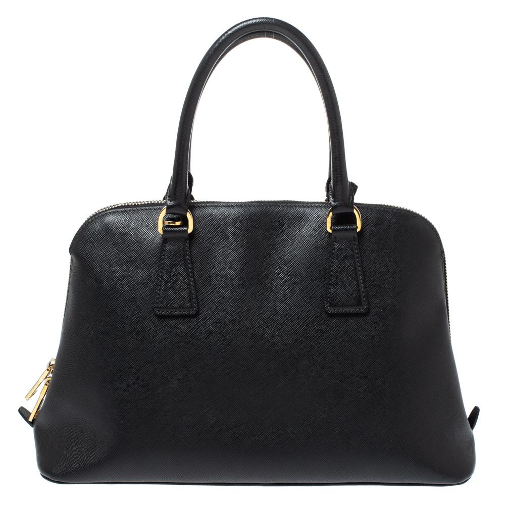 This Promenade is high on appeal and style. Dazzling in black, the bag is crafted from Saffiano Lux leather and features two handles and a shoulder strap. The zip closure leads way to a nylon interior with enough space for your essentials and the