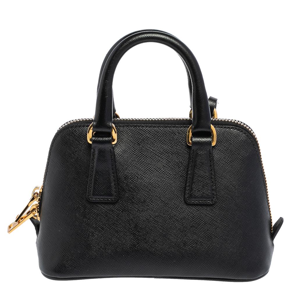 This stunning Promenade bag is high in appeal and style. Dazzling in a classy black shade, the bag is crafted from Saffiano Lux leather and features two rolled handles. The zip closure leads way to a nylon interior with enough space for your