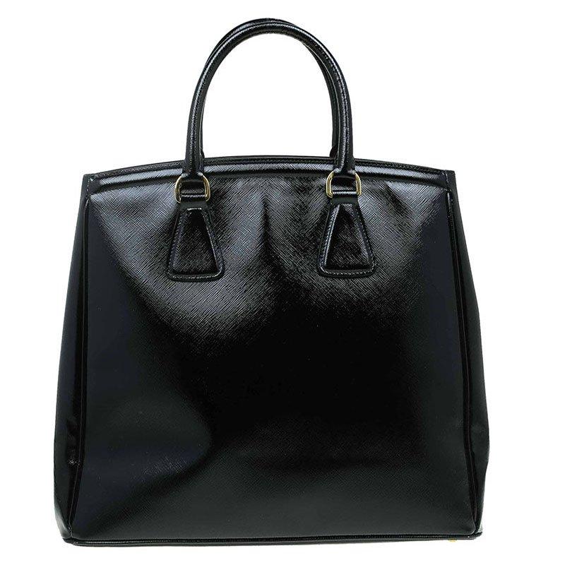 This Prada tote is luxurious and crafted from the finest Saffiano lux leather in black. This bag has a roomy interior with a pocket and top zipped closure, perfect for everyday essentials. Featuring gold tone hardware, the iconic triangular logo and