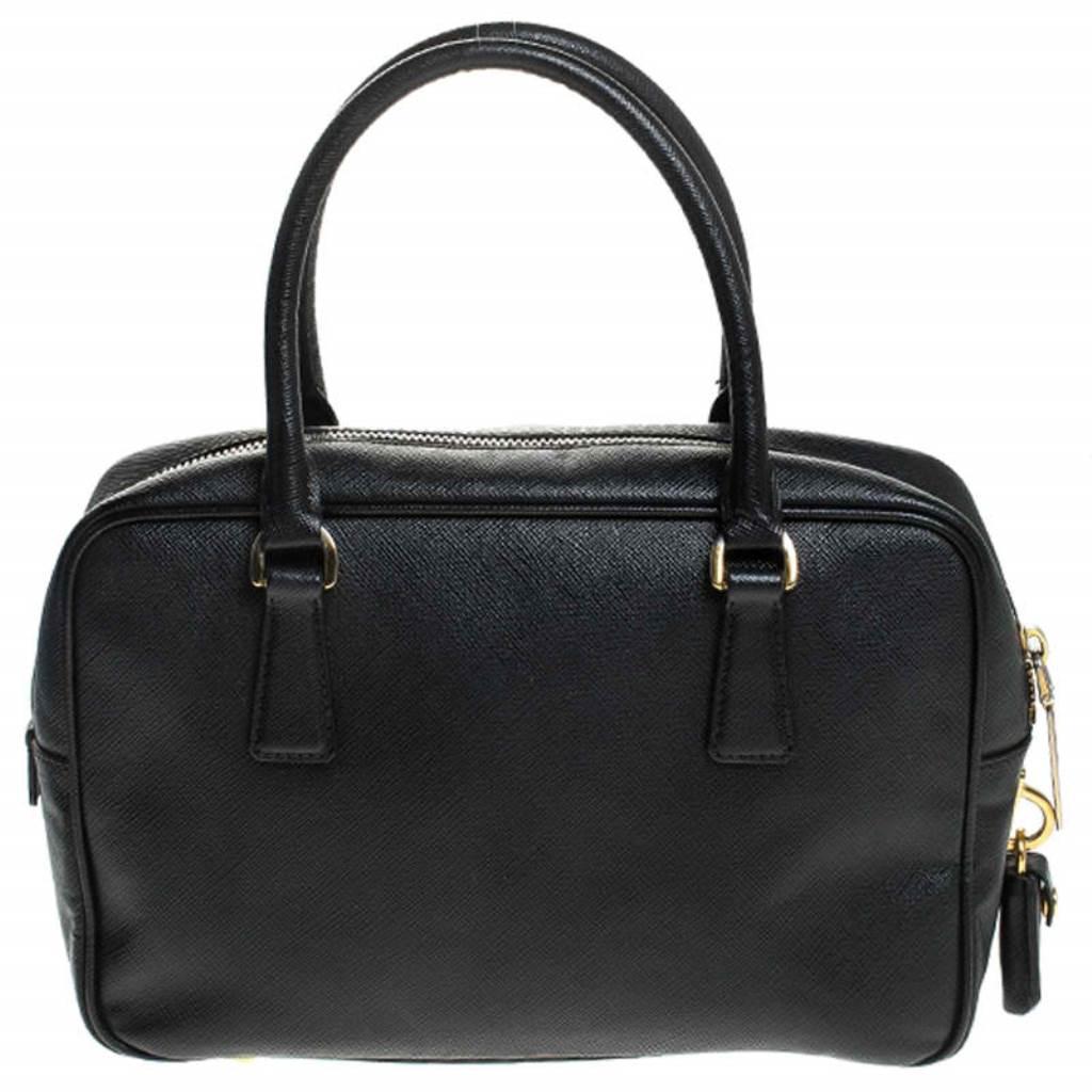 This stunning satchel is high on appeal and style. Dazzling in a classy black shade, the bag is crafted from Saffiano Lux leather and features two rolled handles. The zip closure leads way to a nylon interior with enough space for your essentials