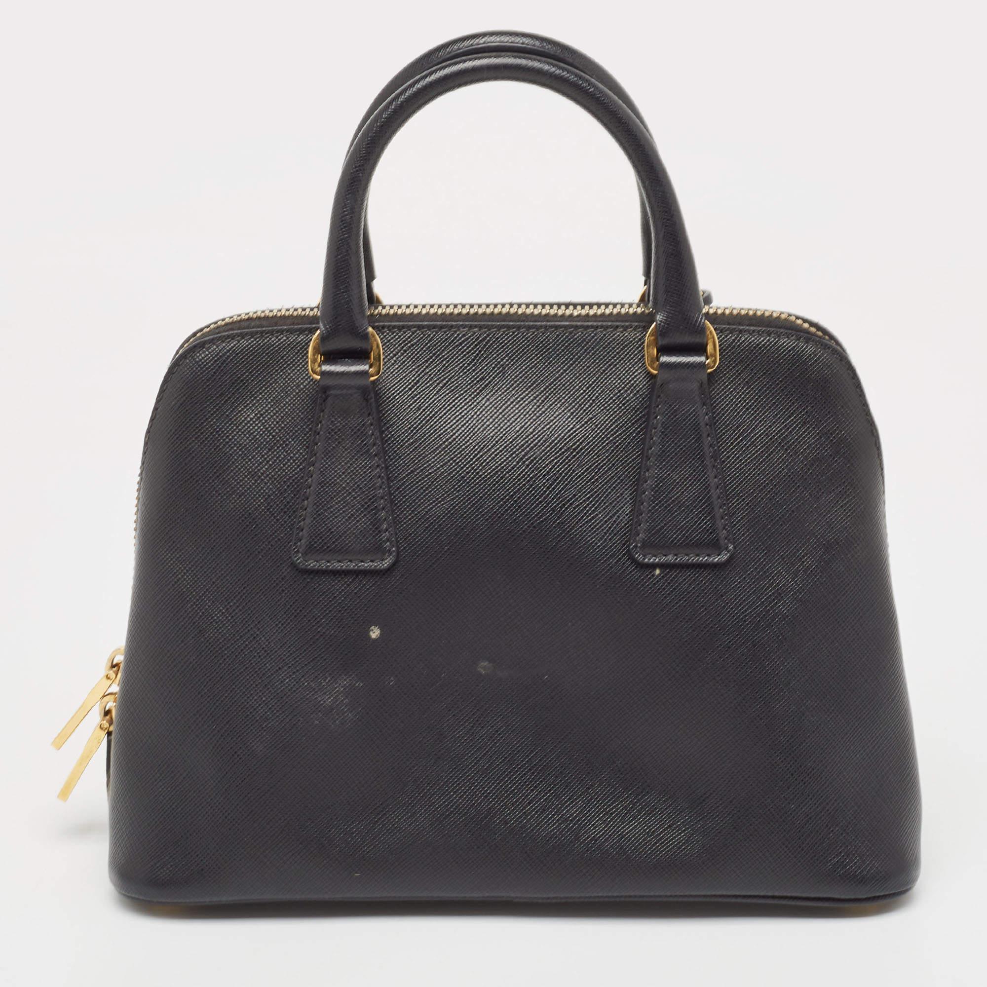 The simple silhouette and the use of durable materials for the exterior bring out the appeal of this Prada satchel for women. It features comfortable handles and a well-lined interior.

Includes: Authenticity Card, Info Booklet, Detachable Strap

