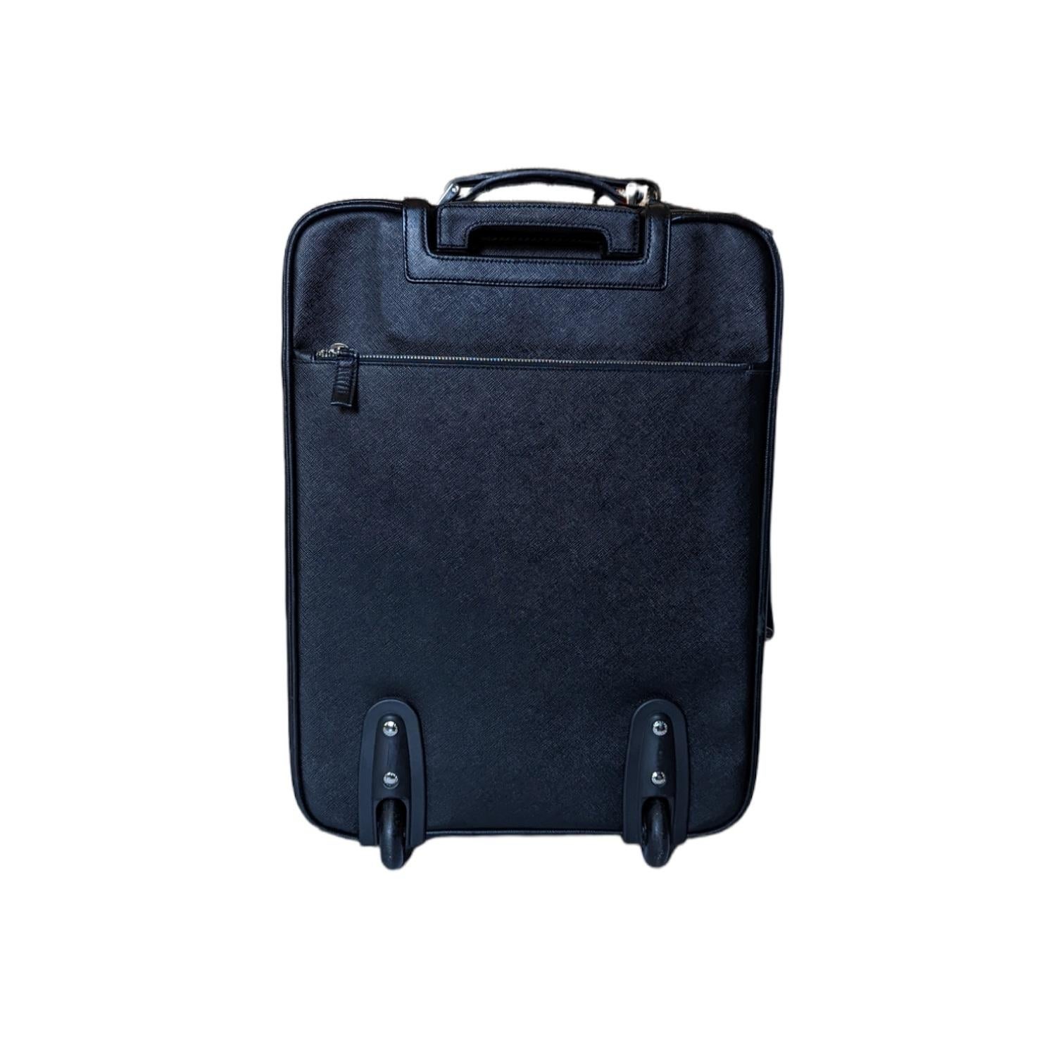 This is an exceptional piece of luggage expertly designed and crafted for your comfort and peace of mind. It is constructed of durable black Prada crossgrain leather on all sides. This is reinforced by cowhide leather trim. It has a wide pocket on