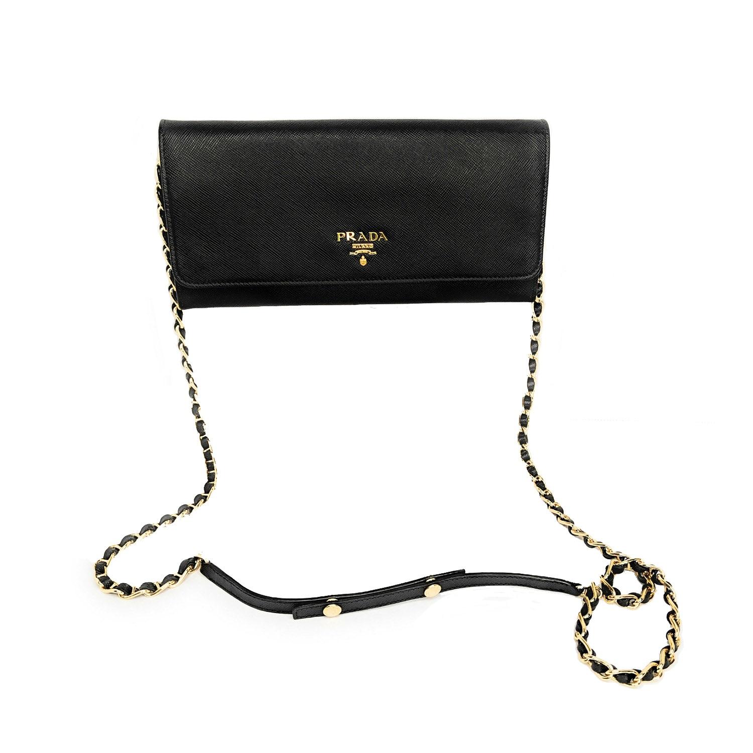 Black leather Prada Wallet On Chain with gold-tone hardware, single chain-link shoulder strap, logo at front, dual slip pockets at flap underside, black leather interior, three compartments; one with zip closure, single cash compartment, six card