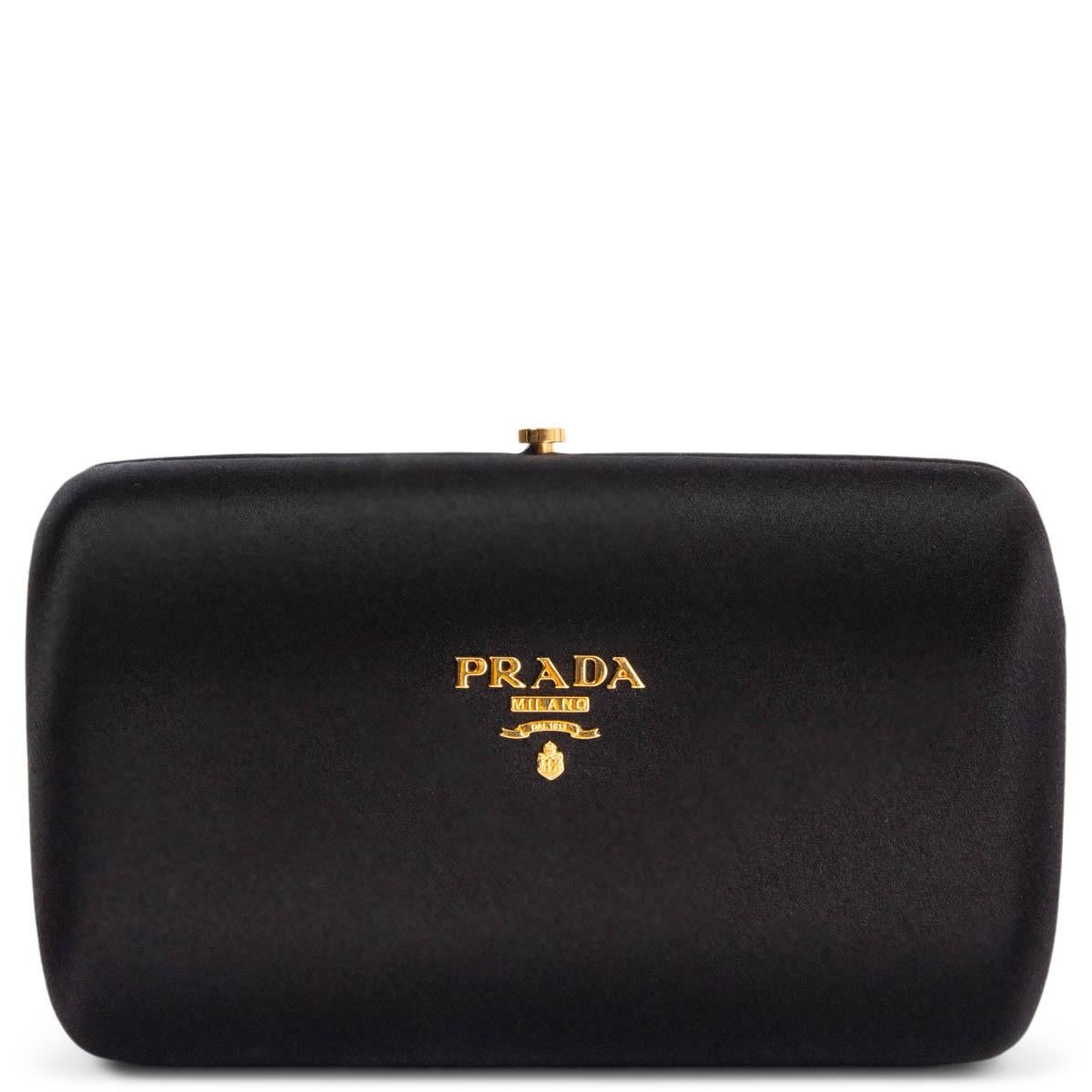 100% authentic Prada box clutch in black silk satin with gold-tone metal logo engraving. Opens with a frame closure to a lilac satin lined interior. Has been carried and shows some soft marks on the outside and on the lining. Overall in very good