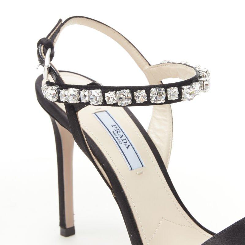 PRADA black satin crystal embellished strappy high heel sandals EU37
Reference: TGAS/B00639
Brand: Prada
Designer: Miuccia Prada
Material: Silk
Color: Black
Pattern: Solid
Closure: Buckle
Lining:  Leather
Extra Details: Black silk satin upper. Clear