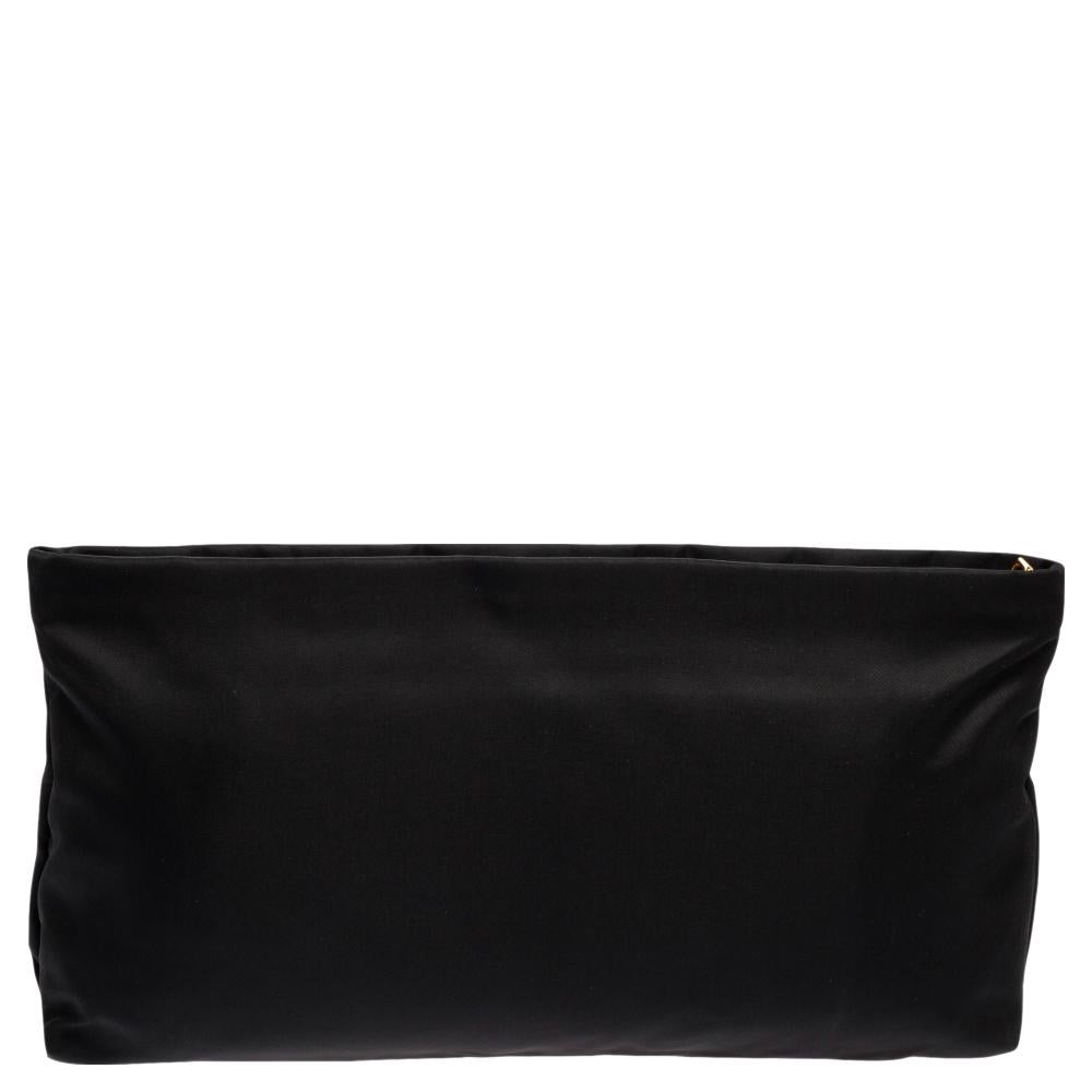 The perfect accessory on a night out is this Prada Satin Jewel Clutch. The exterior is embellished with black gemstones highlighted with a gold-tone hardware outline. Prada detailing at the front and a nylon-lined interior complete it.

Includes: