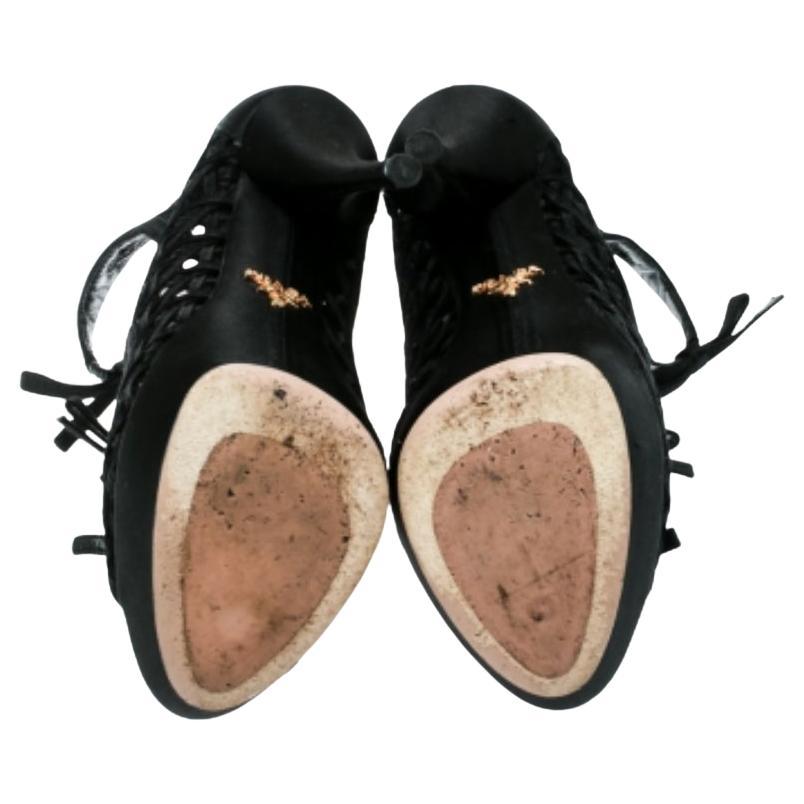 These black ankle booties from Prada were made to delight the tastes of all fashion-forward ladies. They come in satin as open-toe booties with cutouts, back zippers, 13 cm heels and platforms.