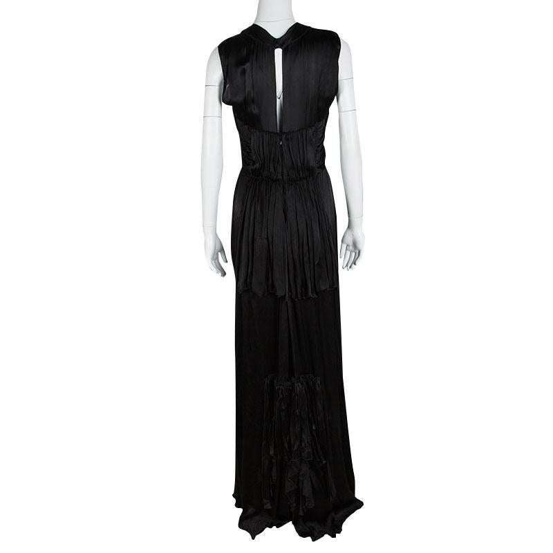 Instantly look red carpet ready when you step out wearing this stunning Prada sleeveless gown. Constructed in black silk blend fabric, this floor length gown features a satin neckline that is embellished with stones and crystals and has a draped