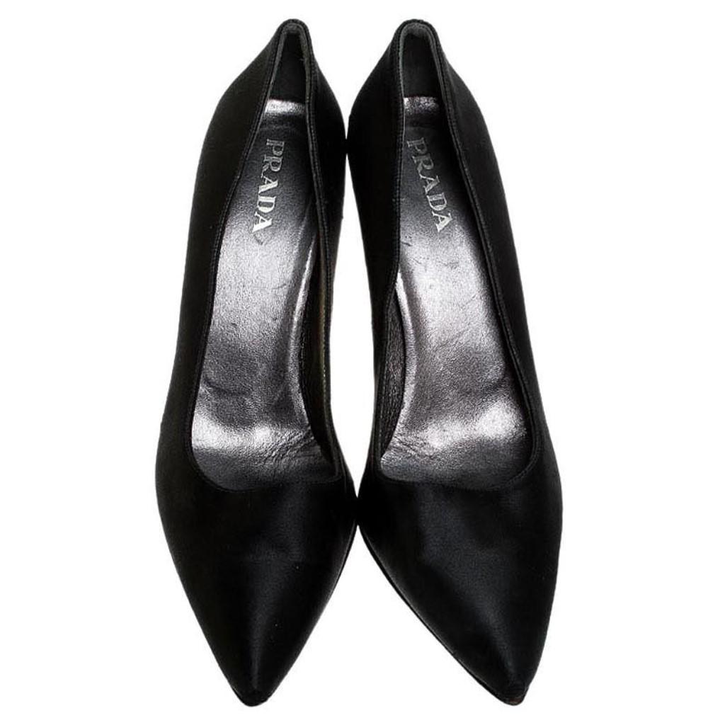 Complete the dressed-up look with this pair of shoes designed by Prada. Instantly elevate your outfit by pairing it with these black pumps. Designed to perfection, they are made out of satin, lined with leather and balanced on 10.5 cm