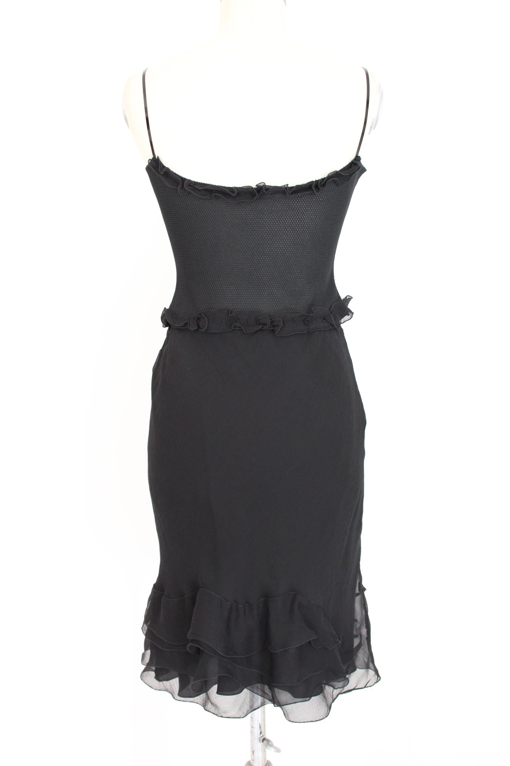 Prada elegant 90s vintage women's suit skirt. Short top with shoulder straps, leather and silk details, mesh type fabric, flared skirt with ruffle, black color, elasticated waist, closure with side clips. Top 100% polyester, skirt 100% silk. Made in