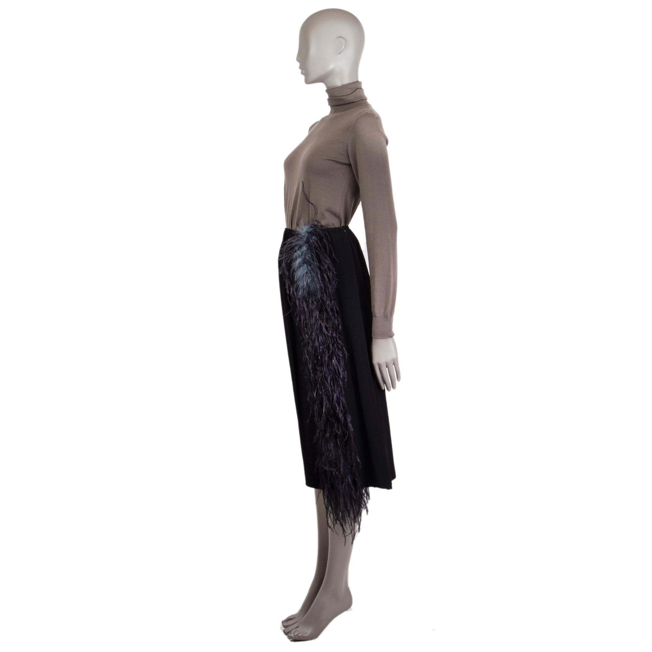 Prada midi skirt in black silk (assumed as tag is missing) and midnight blue and petrol ostrich feathers (assumed as tag is missing). Closes on the side with concealed zipper. Unlined. Has been worn and is in excellent condition. 

Tag Size Missing