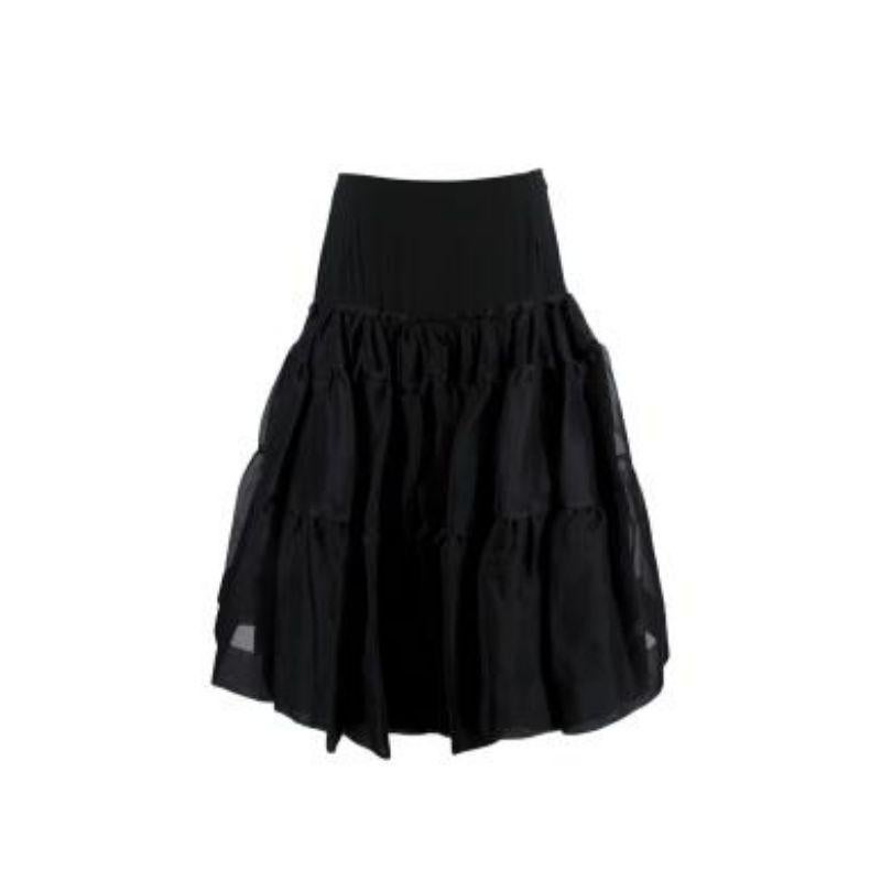 Prada Black Silk Tulle Ruffled Skirt

- Concealed zip fastening
- Ruffled mesh
- Layered pleated effect
- Knee-length

Material
100% Silk

Made in Italy

9.5/10 Excellent condition

PLEASE NOTE, THESE ITEMS ARE PRE-OWNED AND MAY SHOW SIGNS OF BEING
