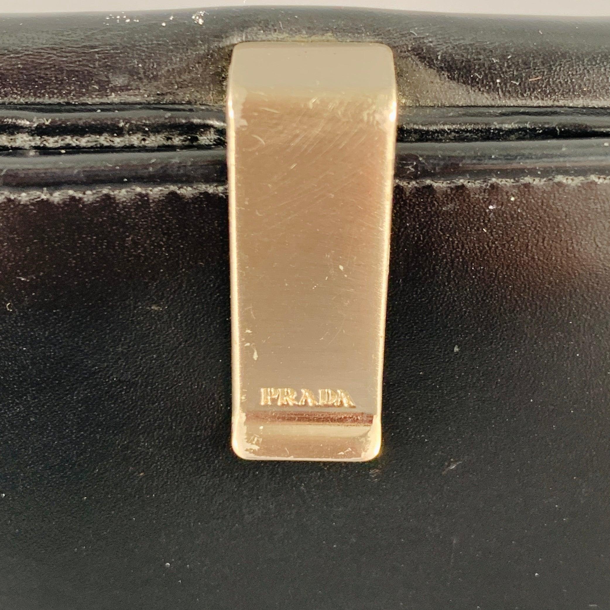 PRADA wallet
in a black leather featuring multiple card slots, coin purse, and clip closure. Made in Italy.Excellent Pre-Owned Condition.5.75 X 4.25 inches 
  
  
 
Sui Generis Reference: 134930
Category: Wallet
More Details
    
Brand: 