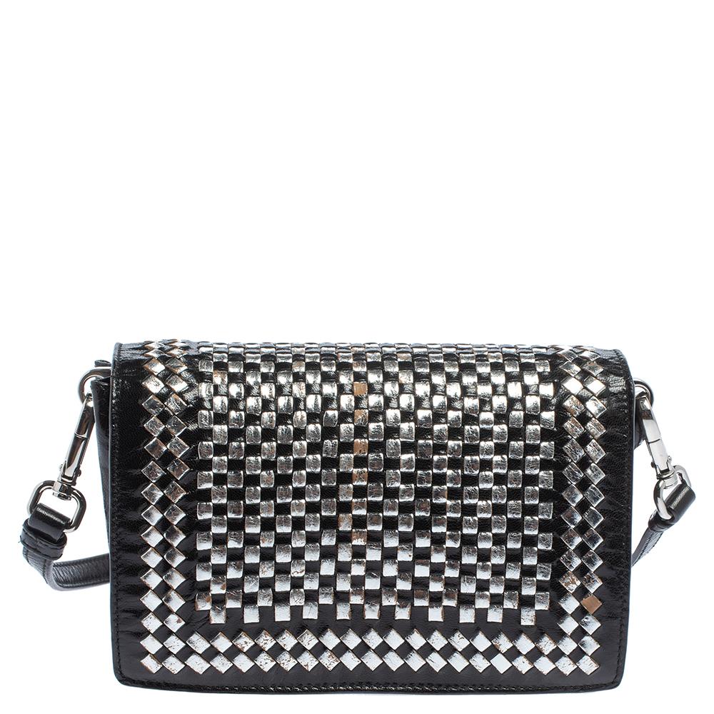 Prada is known for its elegant luxury, and this bag epitomizes the style it has become famous for. Beautifully woven from leather, it comes in black & silver hues and features a front flap with silver-tone closure. It opens to a well-sized interior