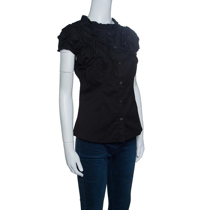 Its time to ace your style game with this fabulous top from Prada. This black top is made of a citto blend and features an artistic silhouette. It flaunts a smock pattern detailing at the front and back, cap sleeves and front button