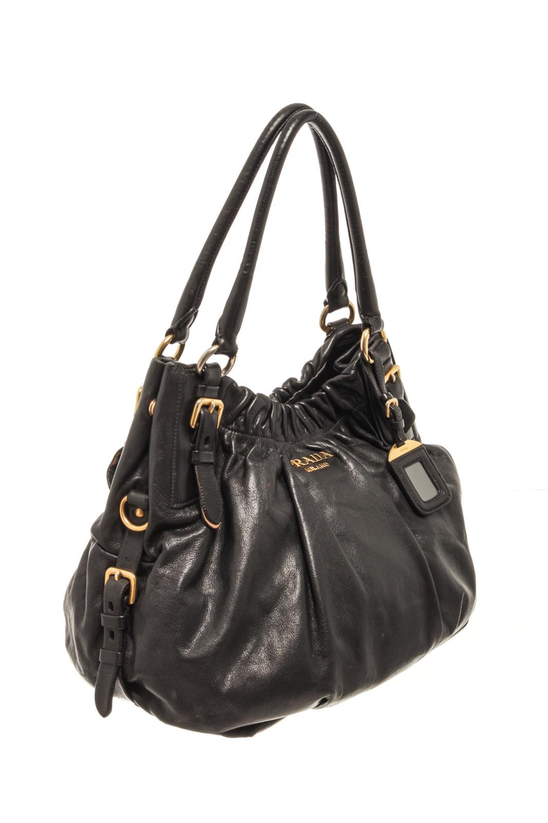 Prada Black Soft Calfskin Leather Gathered Shoulder Bag with shoulder strap, Prada fabric lining, interior pocket, gold tone hardware, snap closure.

86621MSC