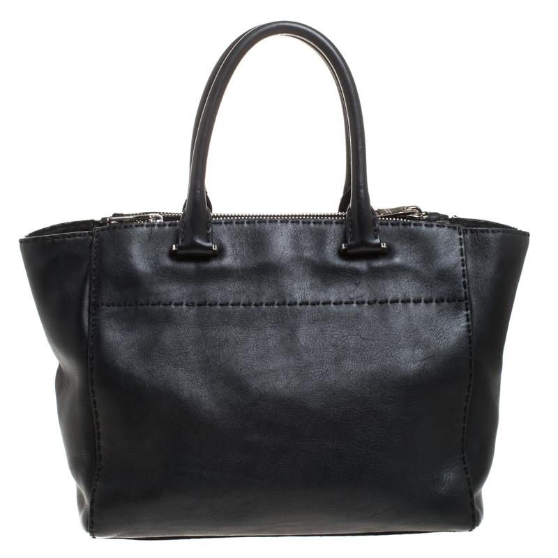 Feminine in shape and grand in design, this Double Zip tote by Prada will be a loved addition to your closet. It has been crafted from leather and styled minimally with silver-tone hardware. It comes with two top handles, two zip compartments and a