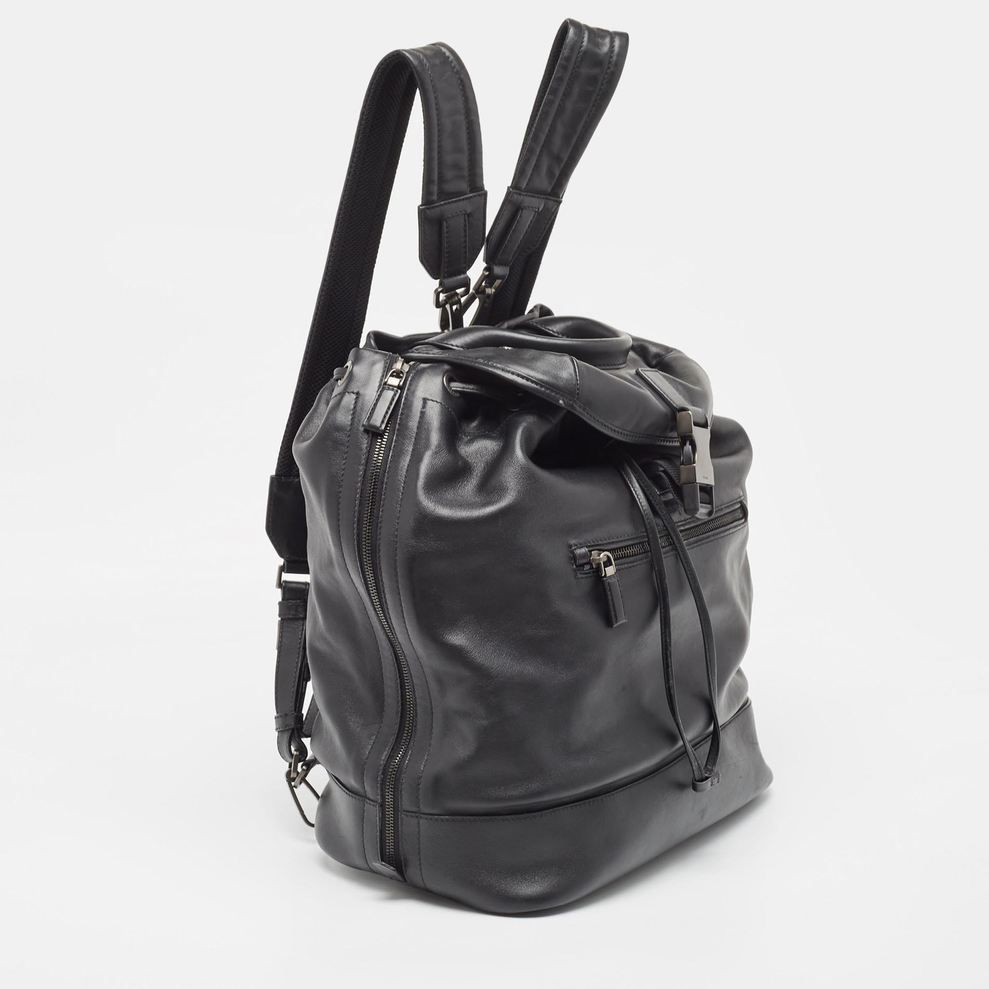 Marked by flawless craftsmanship and enduring appeal, this Prada black backpack for men is bound to be a versatile and durable accessory. It has a practical size.

