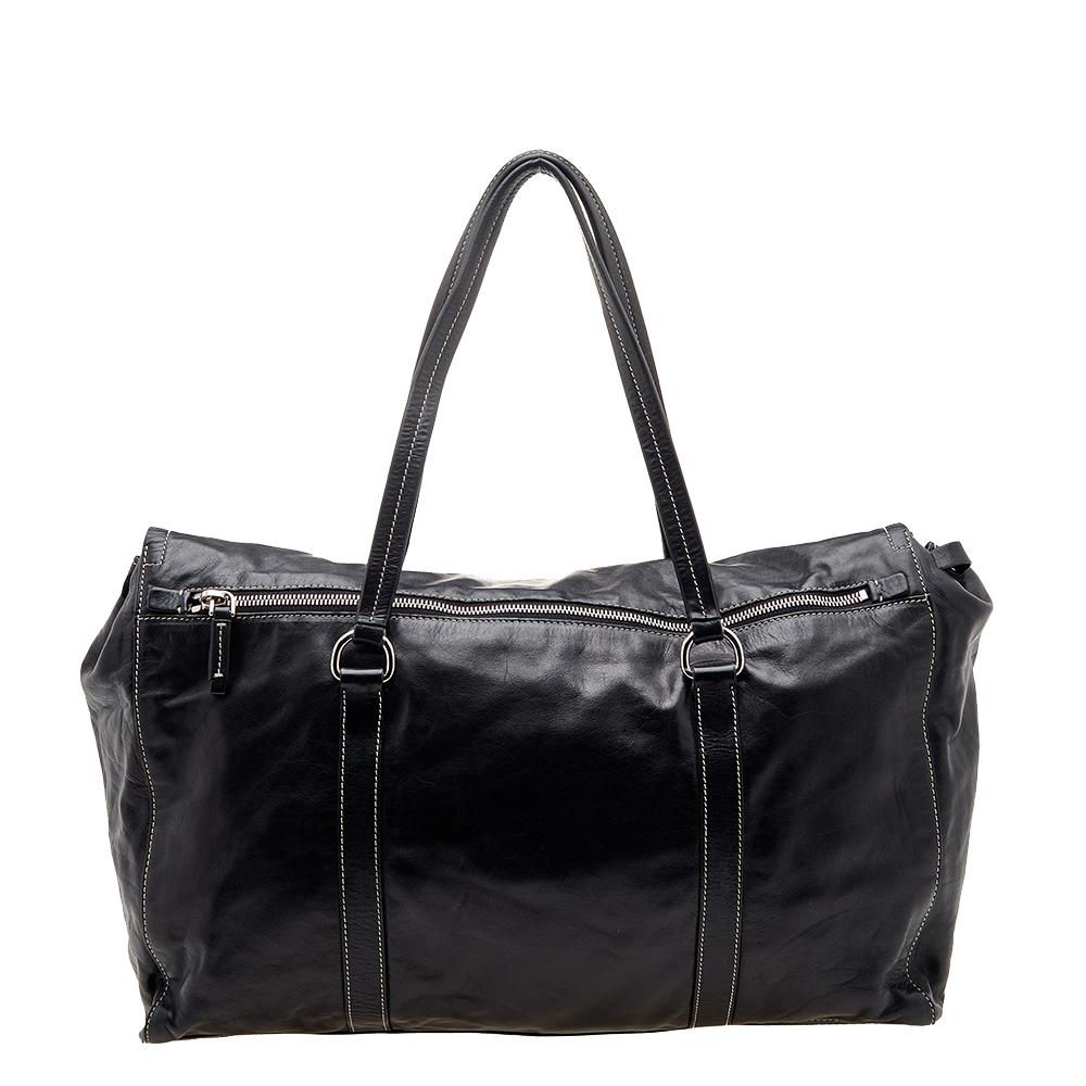 From the house of Prada comes this exquisite satchel for your everyday style. It has a smooth leather exterior and displays a black shade that will match well with most outfits. It is finished with dual handles, silver-tone hardware, and a spacious