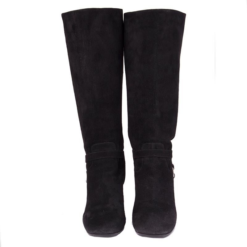 100% authentic Prada stir-up block-heel boots in black suede. Prada logo on the right boot on the bottom is cracked. Overall condition is excellent. Rubber soles have been added. 

Measurements
Imprinted Size	40.5
Shoe Size	40.5
Inside Sole	27cm