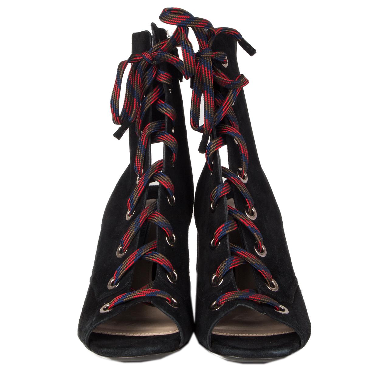 100% authentic Prada lace-up ankle-boots in black suede featuring red, blue, olive green and black striped laces, silver-tone eyelets and gold-tone metal plate on heel. Open with a zipper on the inside. Brand new.

Measurements
Imprinted