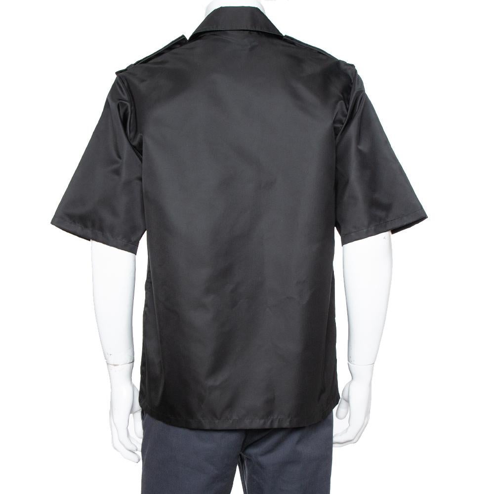 This black-hued shirt from Prada is comfortable to wear. The shirt comes in quality fabric with a simple collar, front button fastenings, short sleeves, and one front pocket. A pair of trousers and shoes will complement the shirt well.

