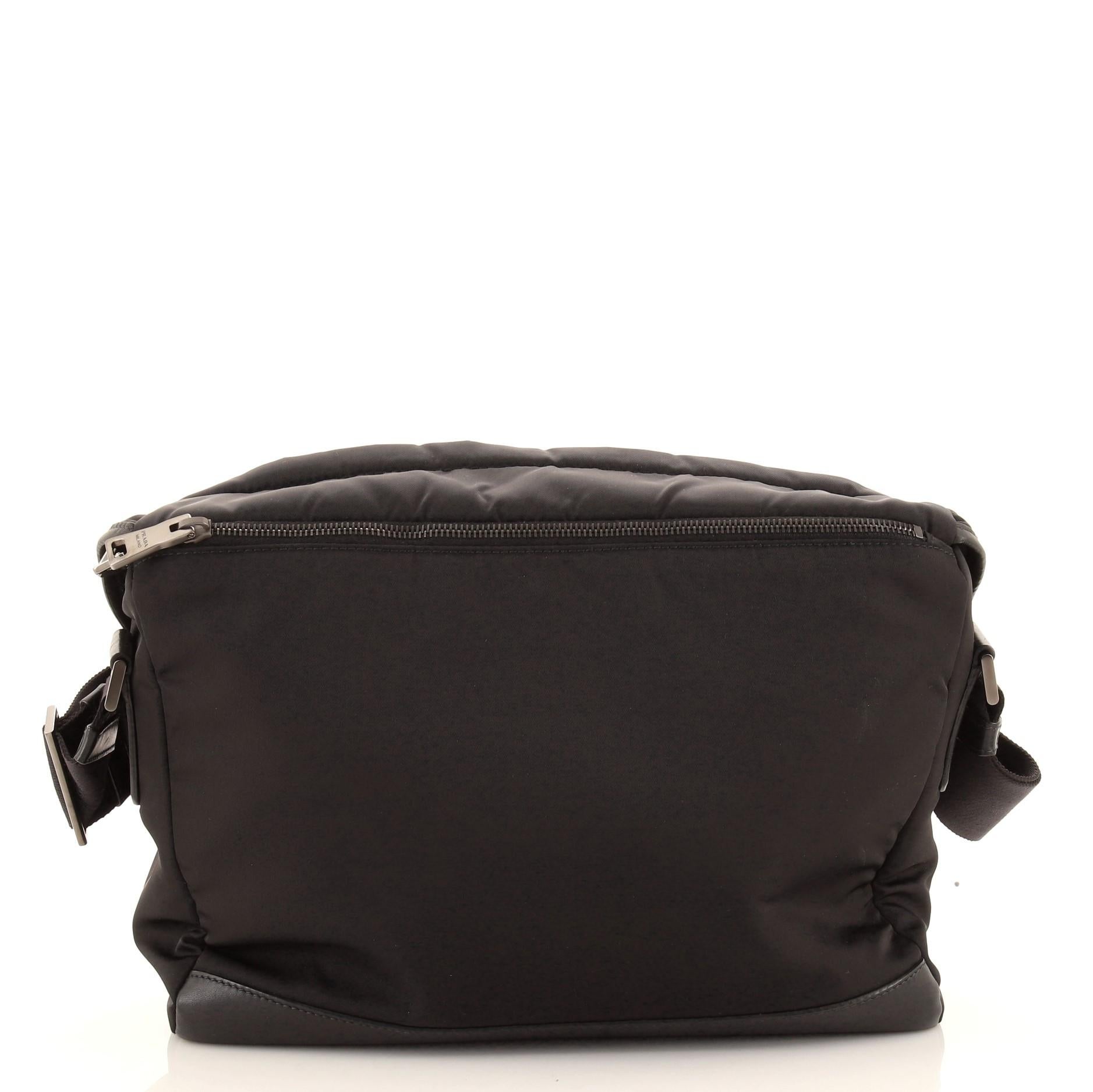 Prada Double Buckle Flap Large Messenger Bag features black durable nylon with fine leather trim details and an adjustable long strap that can be worn over the shoulder or cross-body for hands-free comfort. Back zip pocket, one zipped interior
