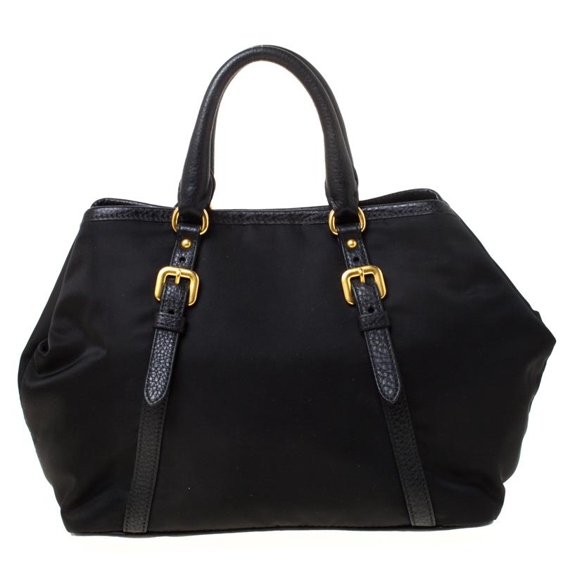 When you carry this Prada creation, be ready to catch admiring glances as this bag is stylish and handy. The bag has been crafted from Tessuto nylon and leather trims in a lovely black shade and equipped with two top handles and gold-tone logo