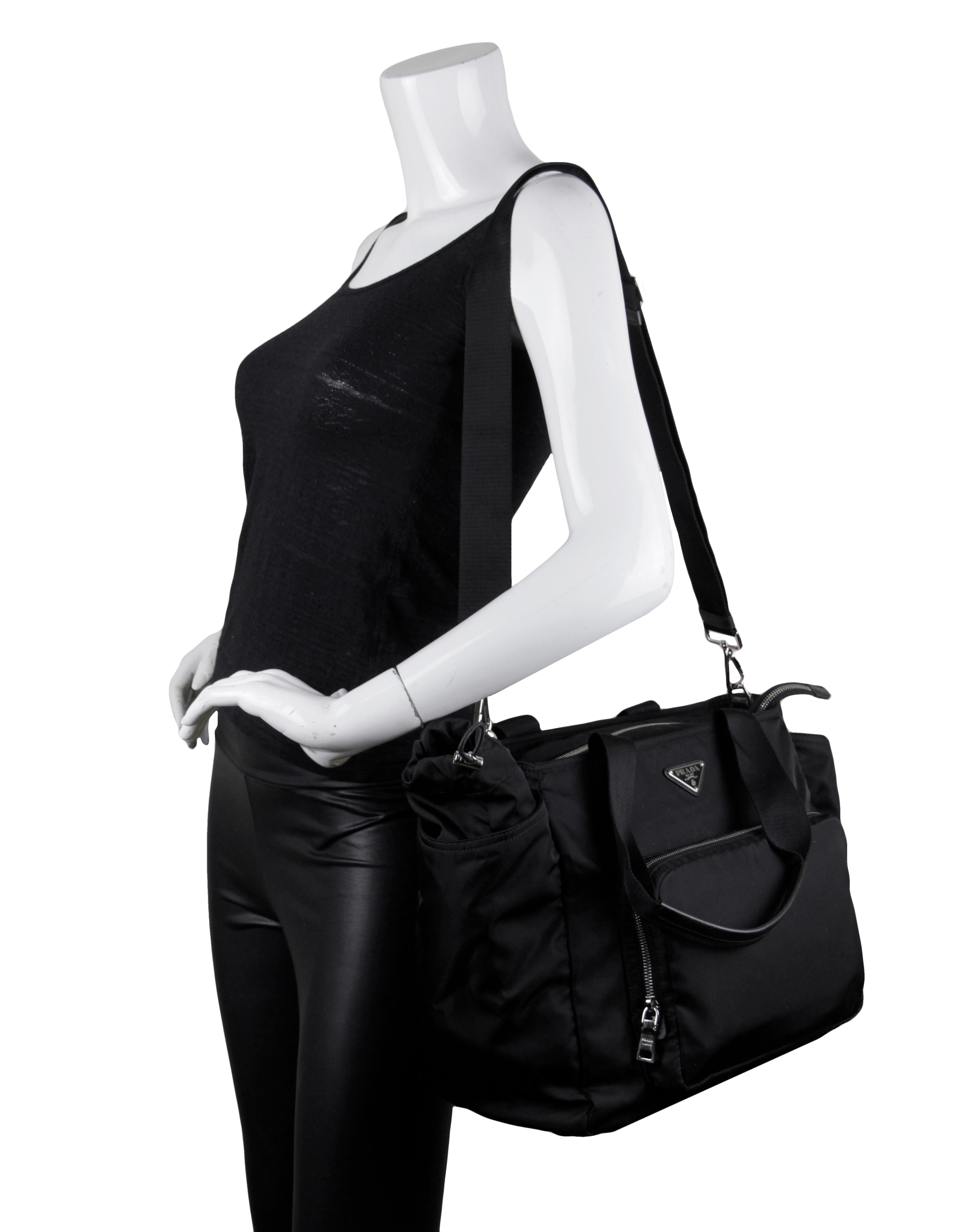 Prada BR4102 Black Tessuto Nylon Baby Diaper Tote Bag

Made In: Italy
Color: Black
Hardware: Silvertone
Materials: Nylon with canvas straps and leather trim
Lining: Black logo textile
Closure/Opening: Zip top
Exterior Pockets: Front zip pocket holds