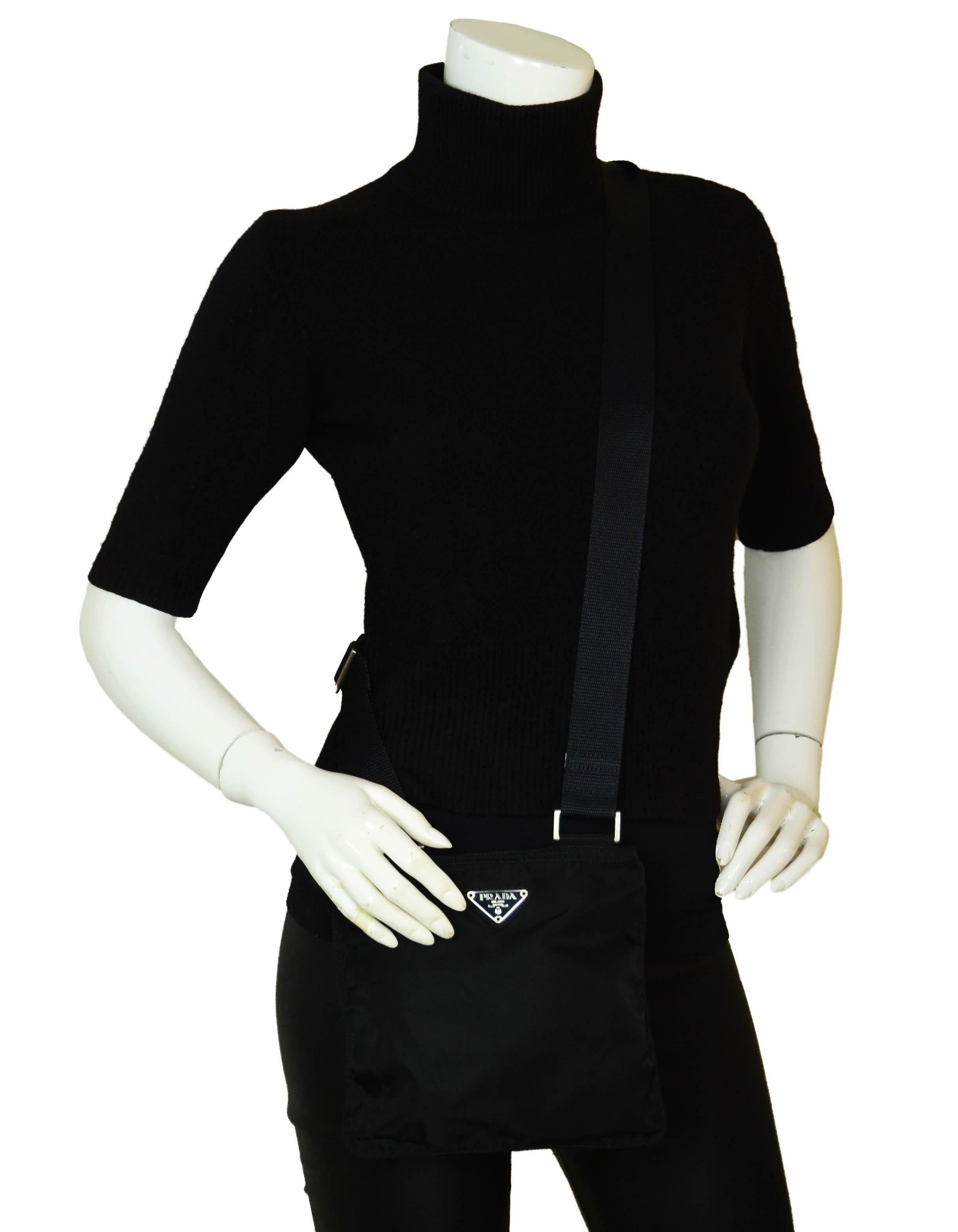 Prada Black Tessuto Nylon Flat Mini Crossbody Bag.  

Made In: Italy
Color: Black
Hardware: Silvertone
Materials: Tessuto nylon with canvas strap
Lining: Unlined
Closure/Opening: Zip top
Exterior Pockets: None
Interior Pockets: None
Exterior