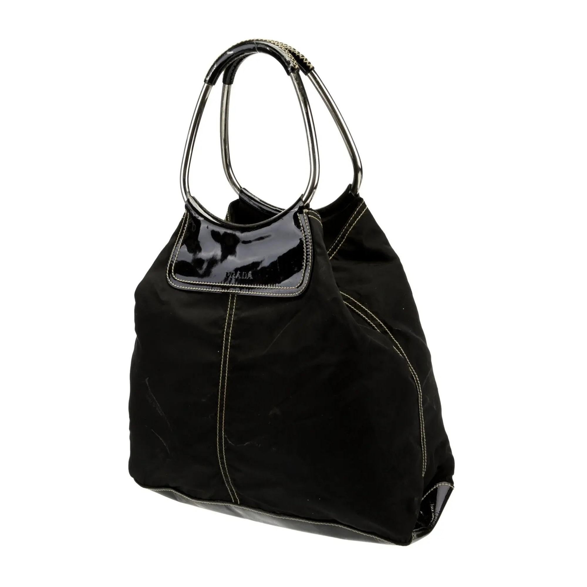 Prada Evening Bag
Nero Tessuto
Tessuto Nylon
Silver-Tone Hardware
Patent Leather Trim
Handles & Dual Shoulder Straps
Leather Trim Embellishment
Nylon Lining & Single Interior Pocket
Open Top

Estimated item measurements
Shoulder Strap Drop: