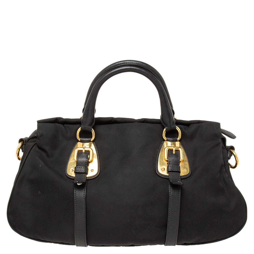 This satchel from the House of Prada is great for everyday use! It is made from black Tessuto nylon, which is embellished with gold-tone hardware. It showcases dual handles and a nylon-lined interior. This satchel will make you look