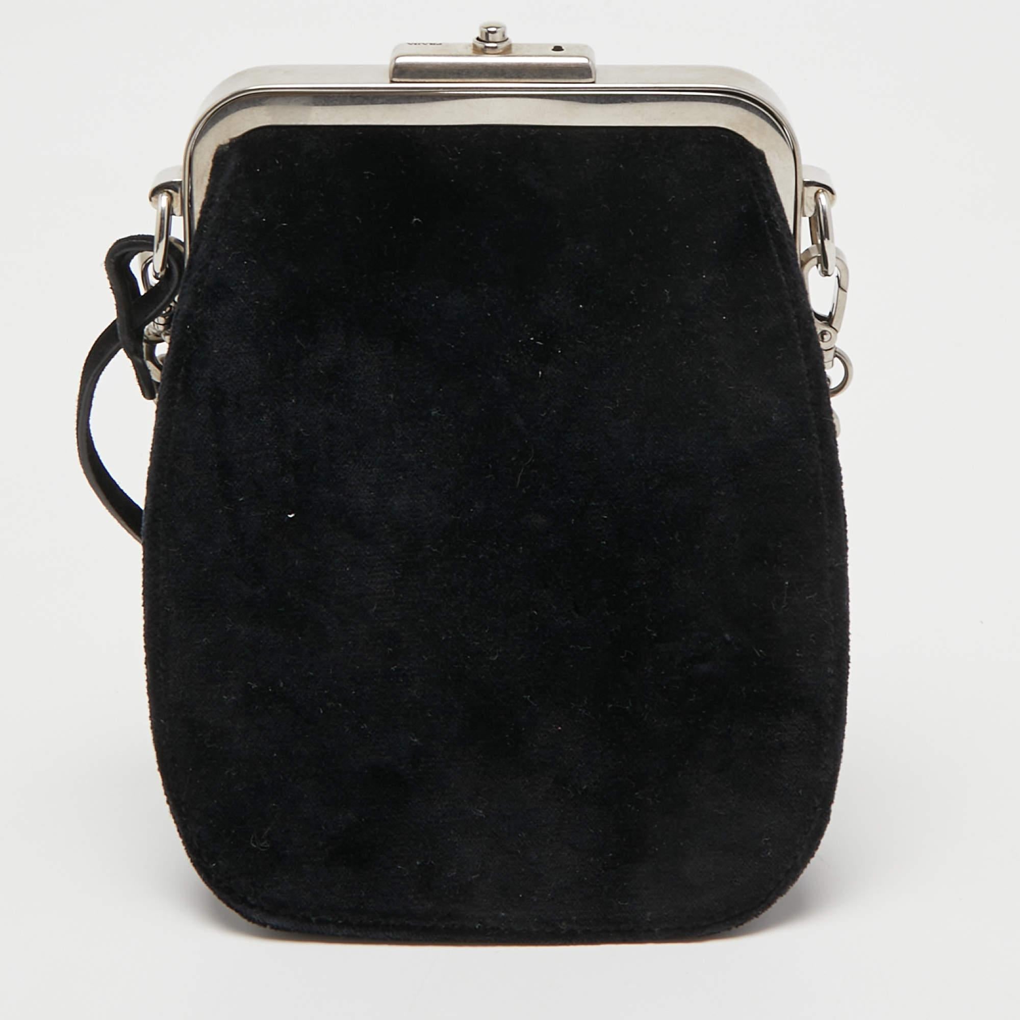 This stylish bag from Prada has been crafted from velvet. It opens to a capacious interior that can easily hold your everyday essentials. The bag is finished with silver-tone hardware and a shoulder strap.

Includes: Detachable strap
