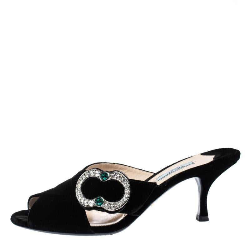 Pick this gorgeous pair of black mules and flaunt your style. This pair from the fashion house of Prada is made from velvet and features crystal embellishments on the vamps, open toes and 7.5 cm heels. Have a striking day out in these!

Includes: