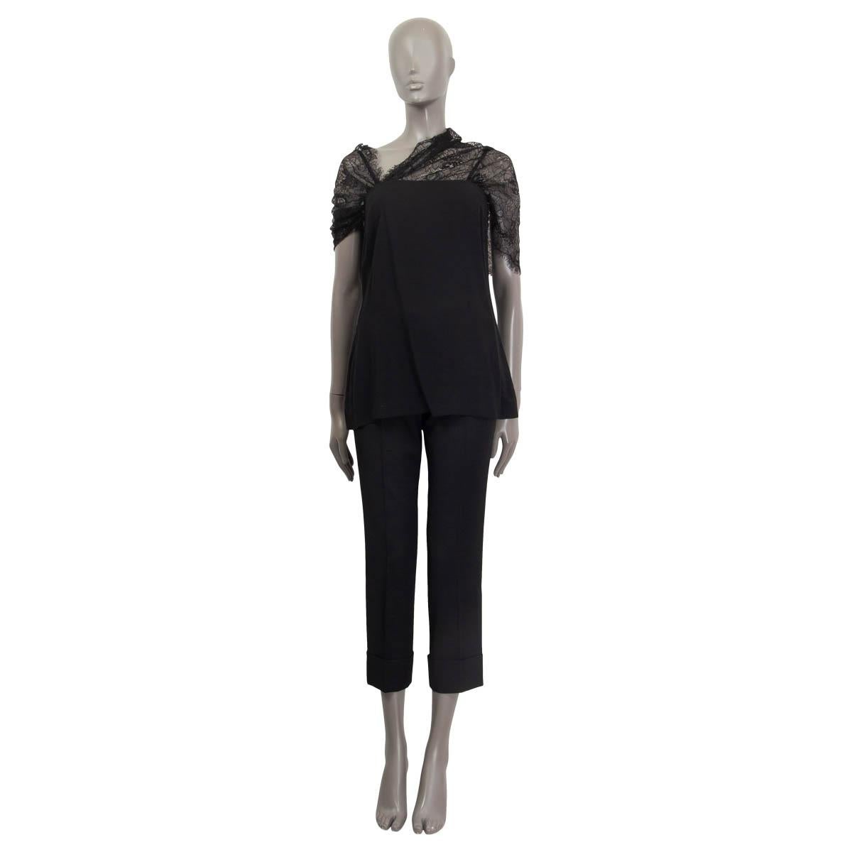 100% authentic Prada short sleeve shirt in black viscose (98%) and elastane (2%). Features a sheer lace collar that can be worn as halter neck or over the shoulder. Opens with a concealed zipper and a hook on the back. Unlined. Has been worn and is