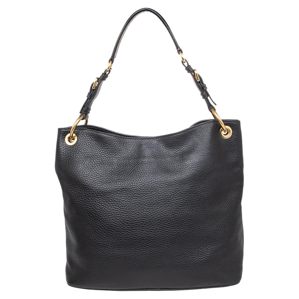 Crafted from leather, this Cervo hobo makes an impressive addition to any stylish closet. It features a quality nylon and leather lining that makes the bag durable. This Prada bag is just right for the handbag lover in you. Go sleek with this black