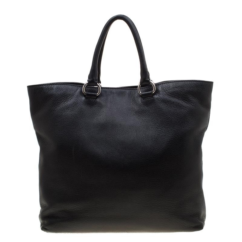 Make a wonderful appearance by adorning this plush and high-class shopper tote. The excellent leather exterior is durable and brings volume to the bag. Lined from nylon, this creation features a spacious interior secured by a silver-tone zipper.