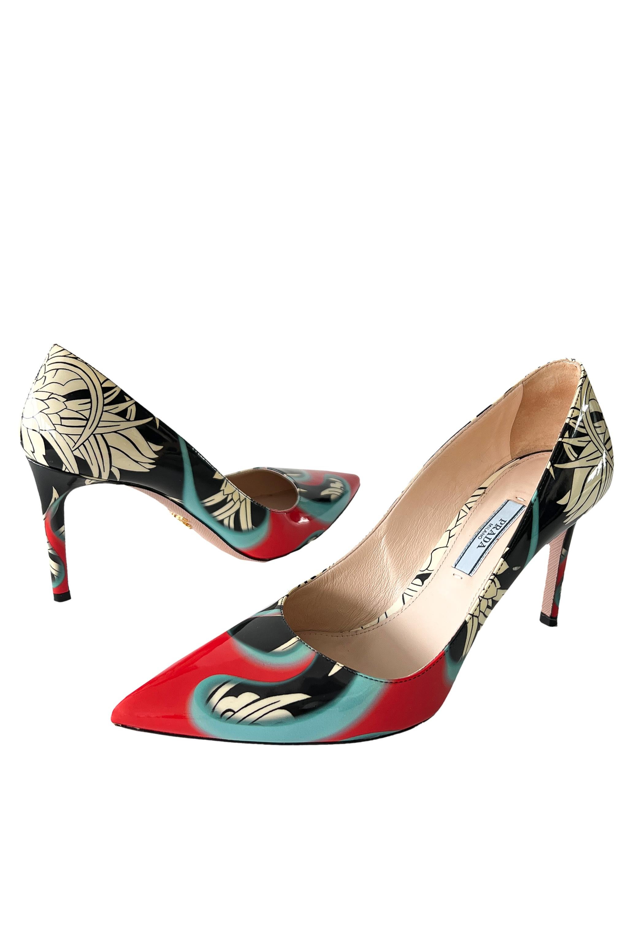 Resurrection Vintage is excited to offer this pair of patent leather Prada heels that feature a black and white floral graphic with red and blue flames, pointed toe, stiletto heel, beige insole, and graphics that were seen on the 2018