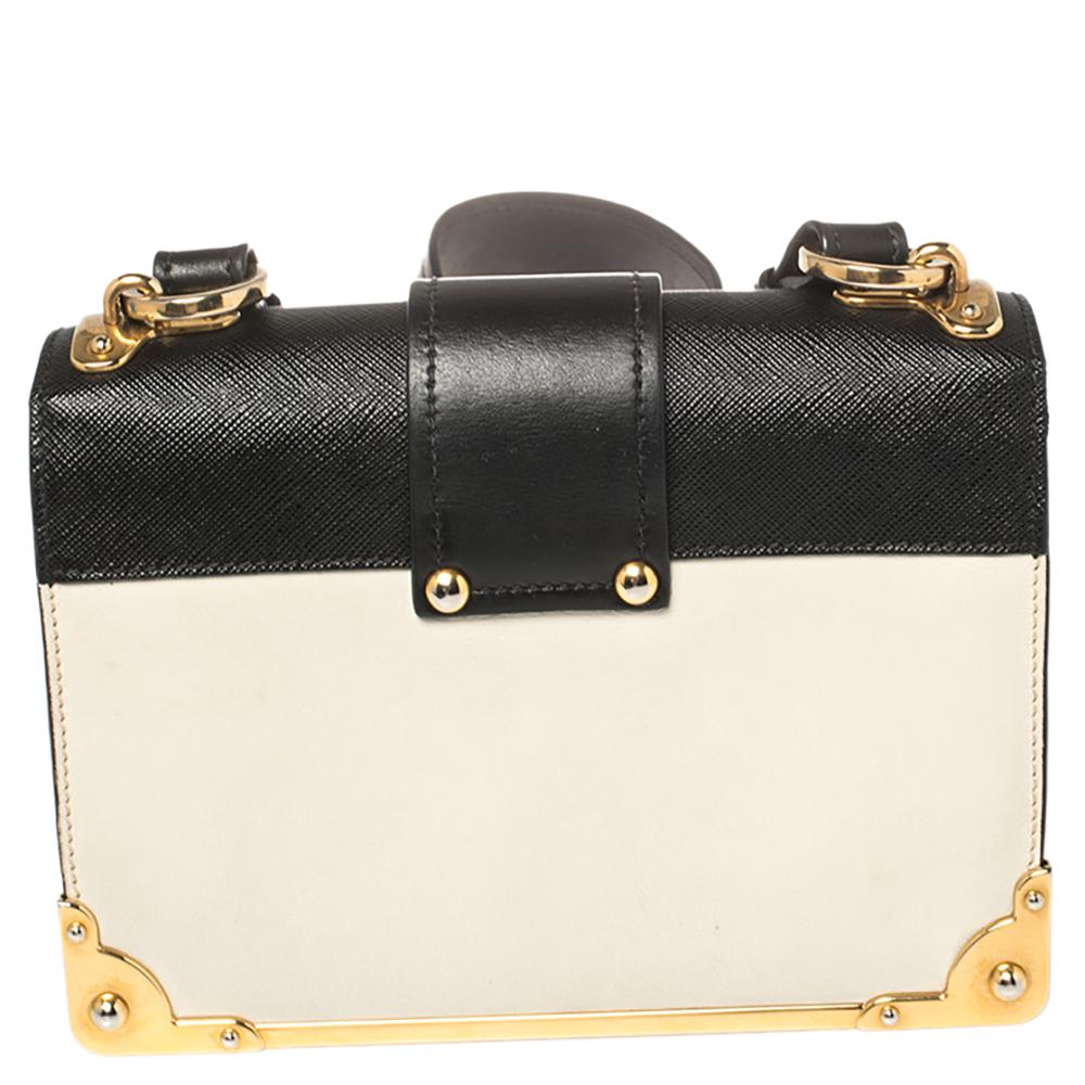 Inspired by valuable books from ancient times, the Prada Cahier bag is a best-seller. This shoulder bag is crafted in Italy with leather. It features a gold-tone tuck-in loop at the front that adds a touch of contrast. The strap with the brand logo