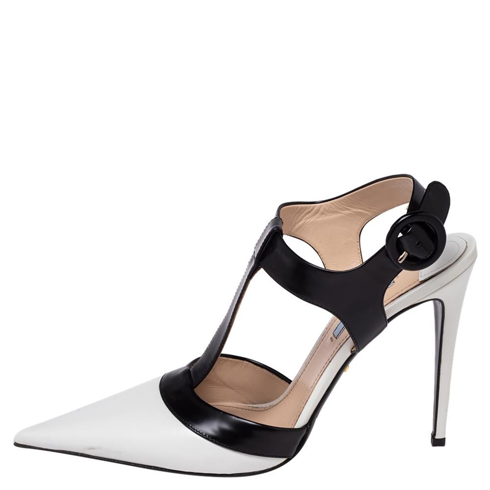 We're greatly impressed by these sandals from Prada! They are crafted from leather in black and white hues. Featuring a pointed toe and a T-strap silhouette, they are equipped with buckled ankle straps, comfortable leather-lined insoles, and 12 cm