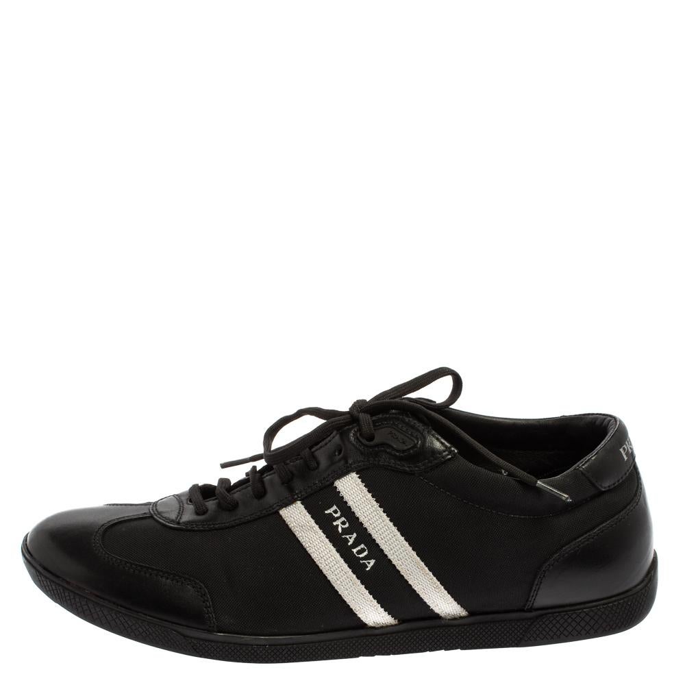 These Prada low top sneakers are the embodiment of style and comfort. Rendered in black color and crafted with nylon and leather, these impressive sneakers are accented with lace-ups and the brand label on the sides. They are also graced with