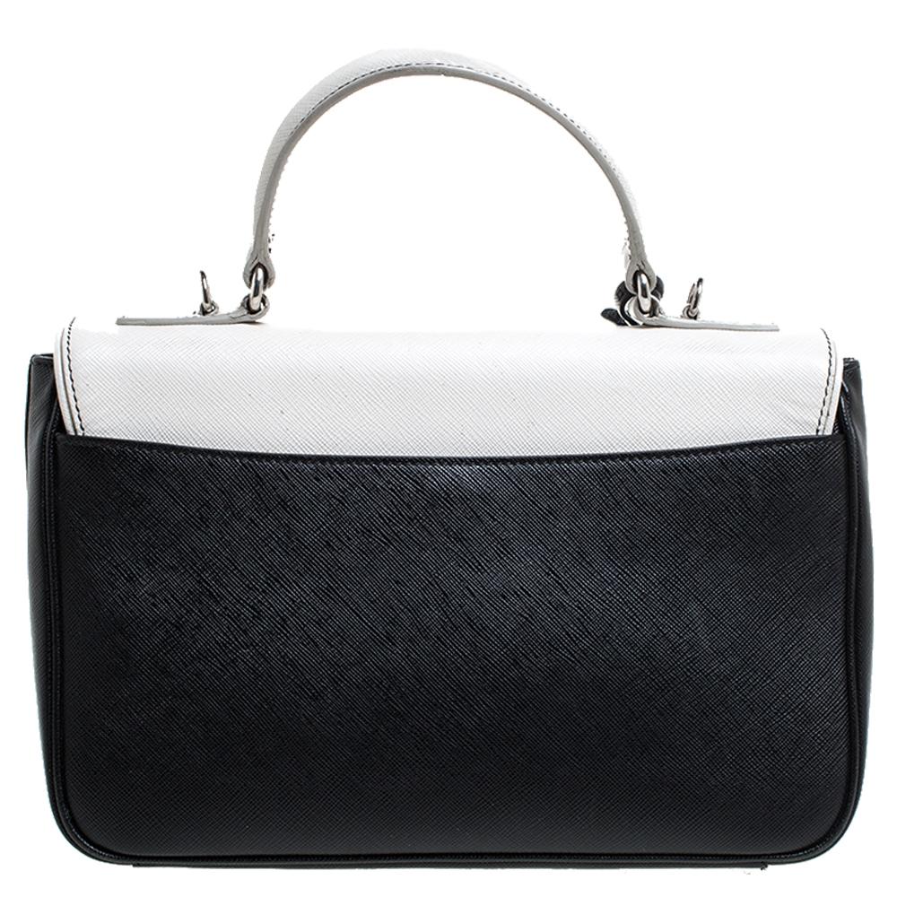 This bag from Prada comes crafted from Saffiano Lux leather and features a front silver-tone lock. It has a top handle, a detachable shoulder strap and the flap opens to a spacious leather-lined interior that can easily store your daily essentials.