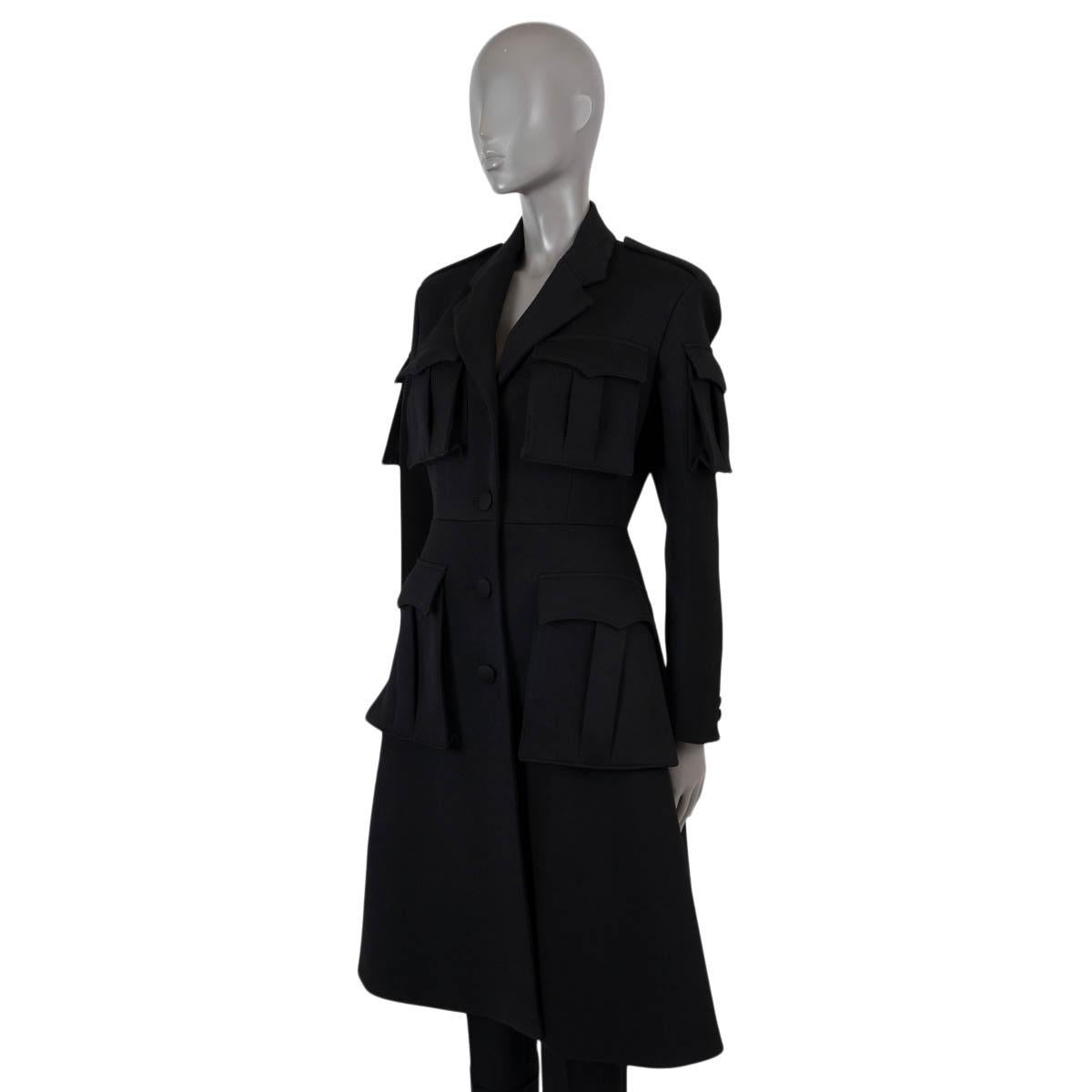 100% authentic Prada gaberdine coat in black wool (100%). Features a tailored silhouette, notch lapels, epaulettes, four flap pockets on the front and two on the sleeves. Closes with buttons on the front and is lined in. Has been worn and is in