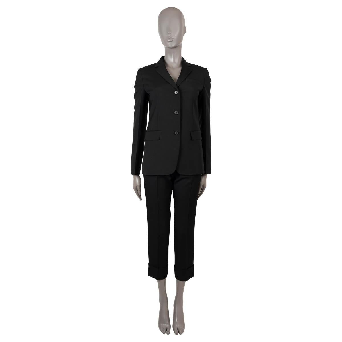 100% authentic Prada classic notch lapel blazer in black virgin wool (100%) and lined in black viscose (100%). Thes design features two front flap pockets, one slit chest pocket, belt loops, a slitted back and three front buttons. Has been worn and
