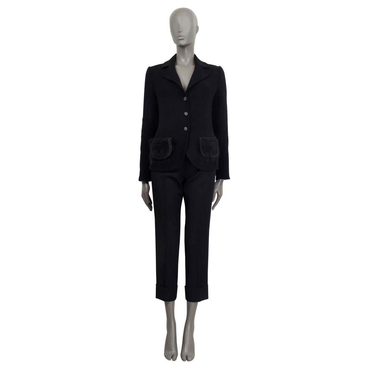 100% authentic Prada blazer in black wool (100%). Features padded shoulders and two fur and chain embellished pockets on the front. Opens with three black buttons on the front. Unlined. Has been worn and is in excellent condition.

Measurements
Tag