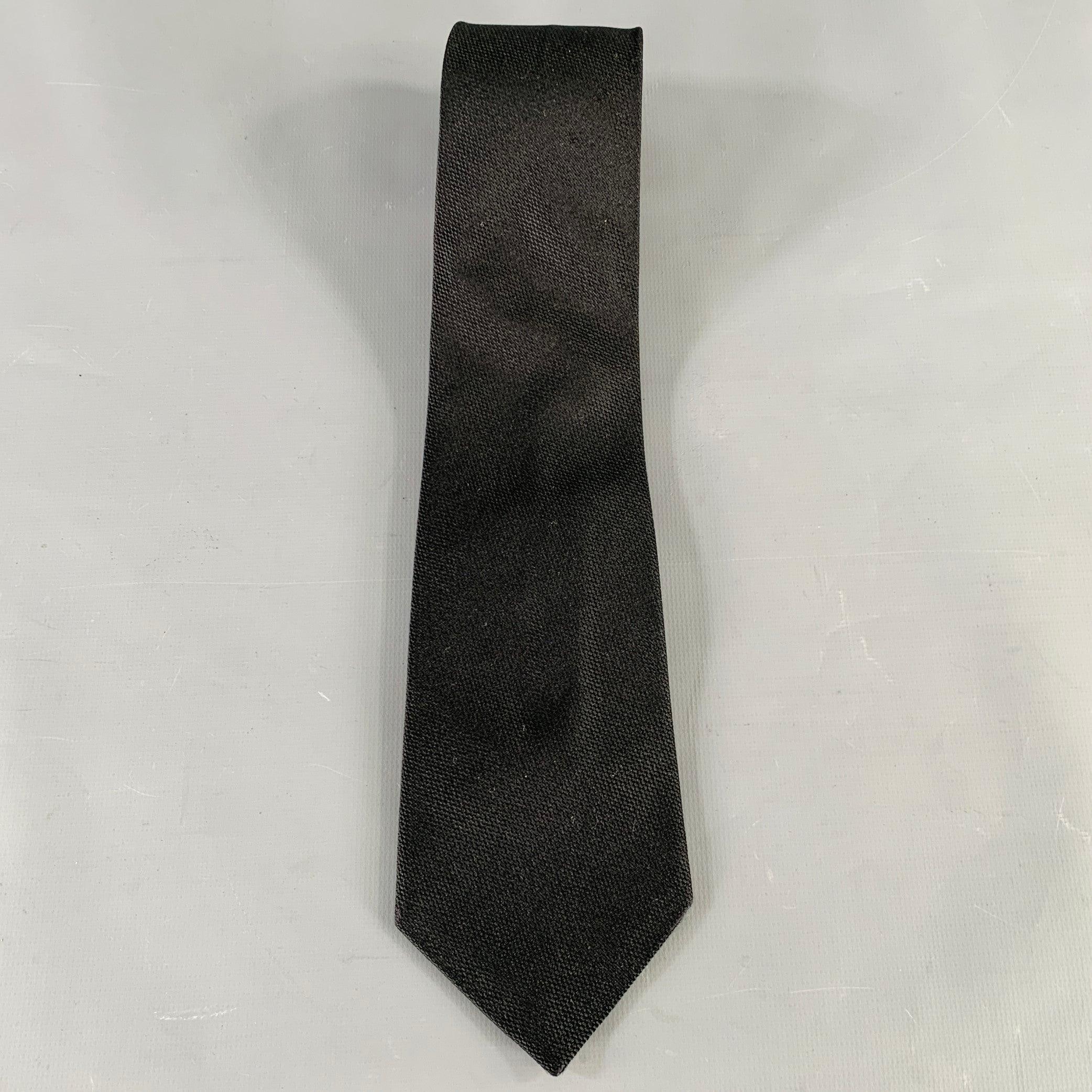 PRADA necktie
in a black silk featuring a woven design and narrow style. Made in Italy.Very Good Pre-Owned Condition. 

Measurements: 
  Width: 3.25 inches Length: 58.5 inches 
  
  
 
Sui Generis Reference: 135854
Category: Tie
More Details
   